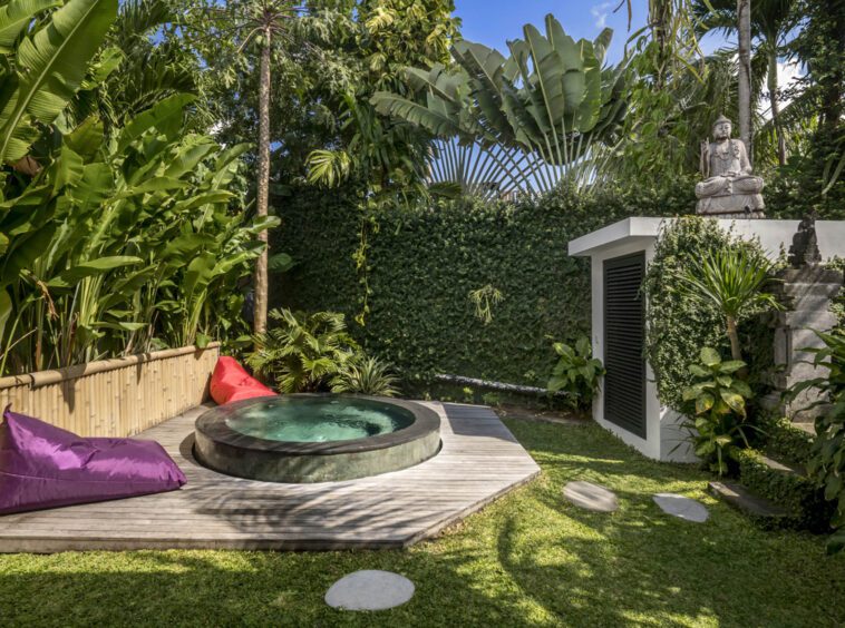 Outdoor jacuzzi area with two bean bags next to it