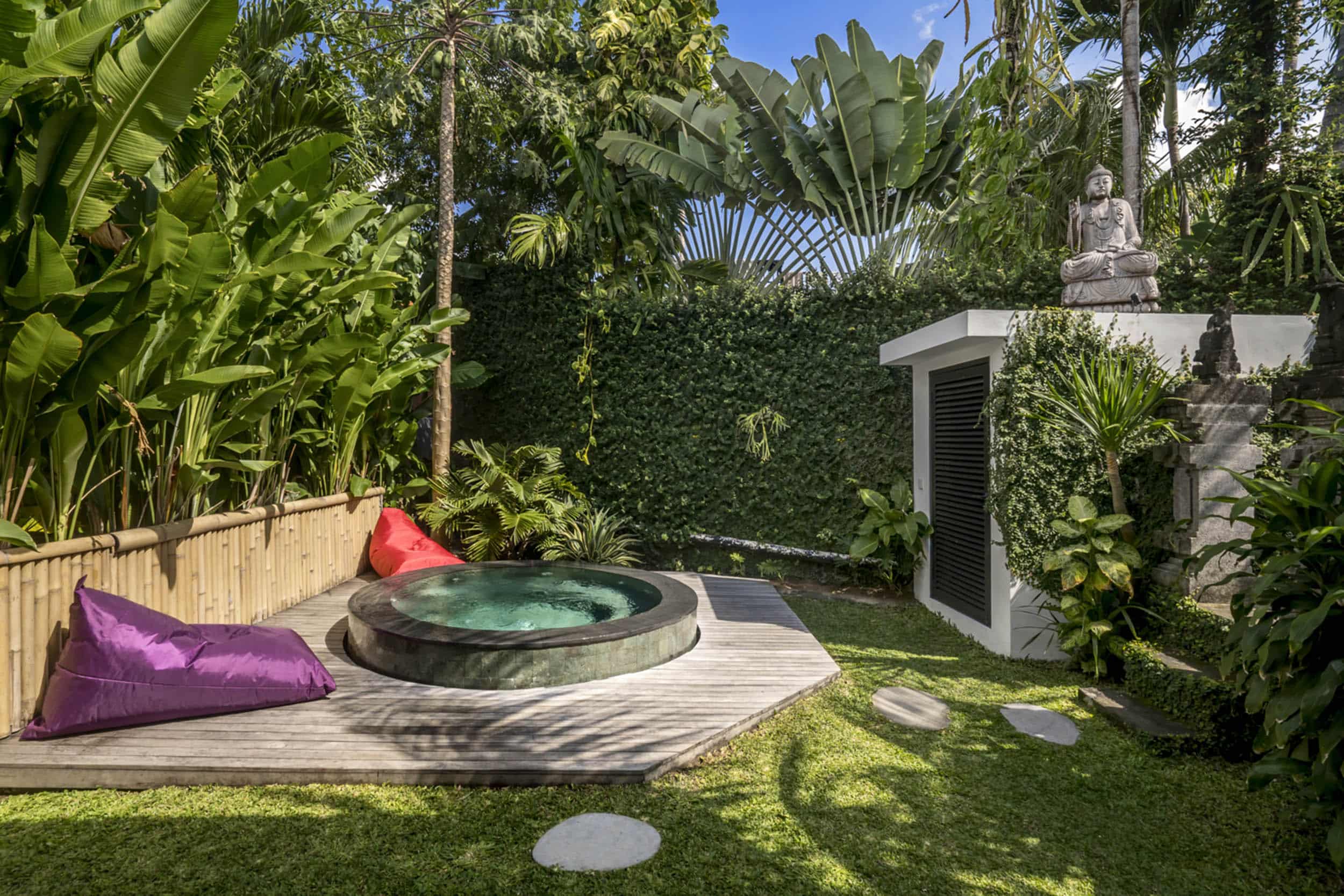 Outdoor jacuzzi area with two bean bags next to it