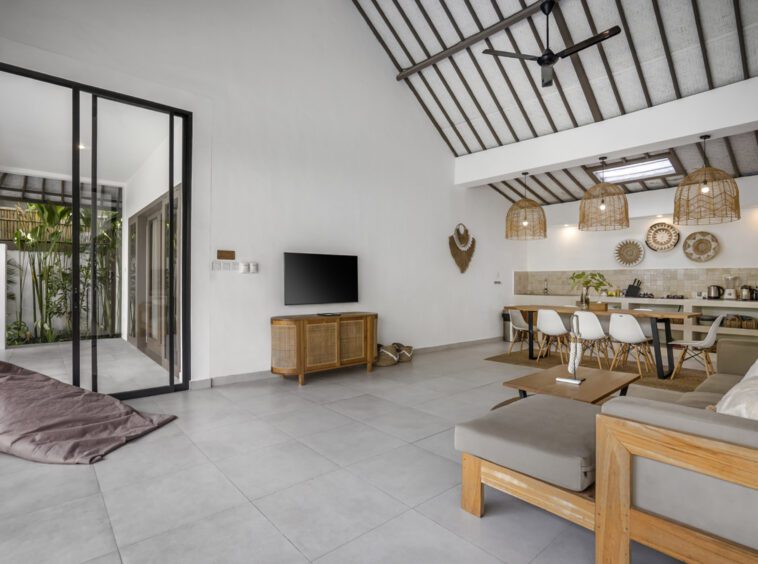 Villa Moju couch facing the TV with the kitchen in the background