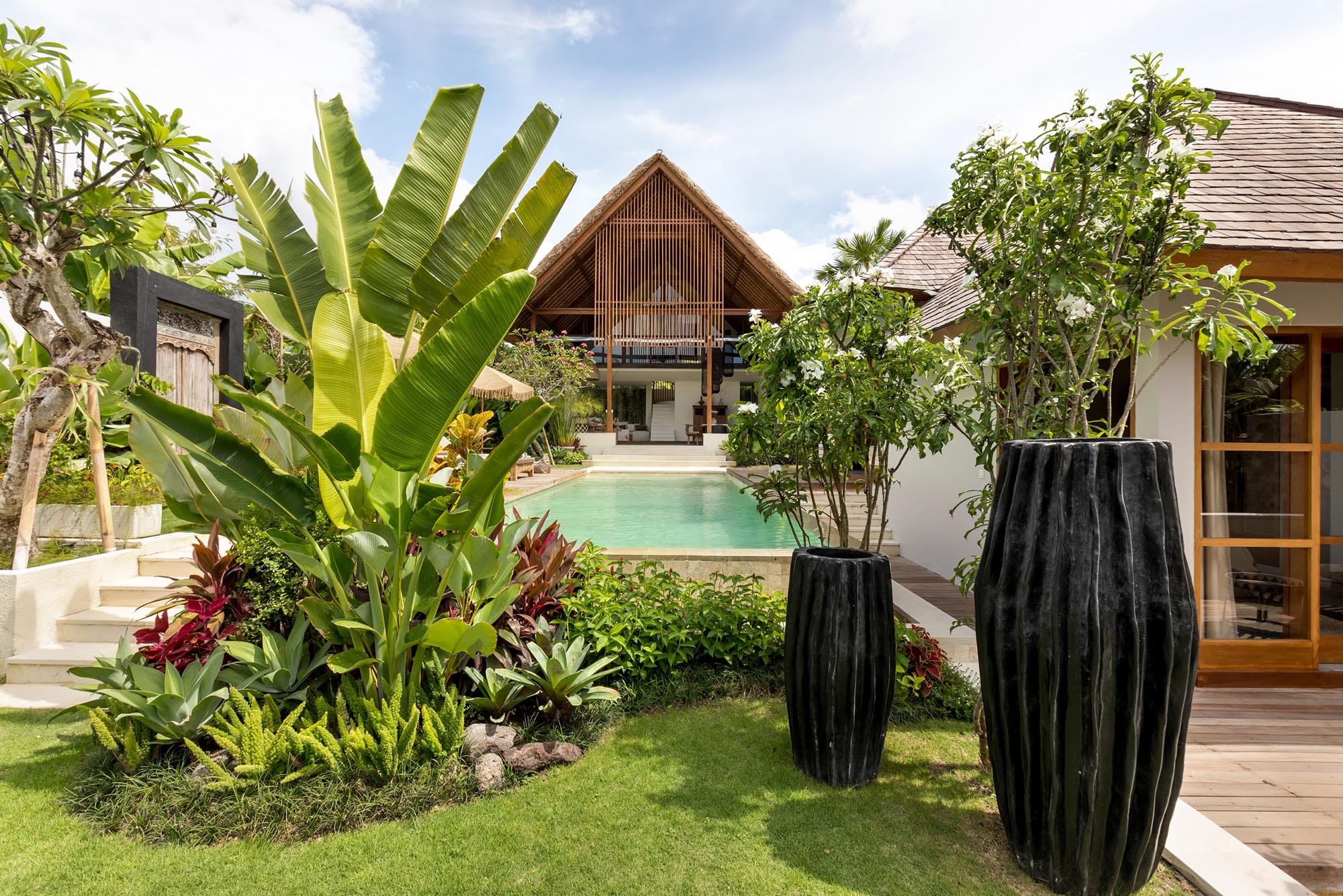 Vilal Chempaka in Canggu with a private pool that is surrounded by lush greenery