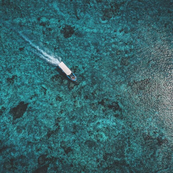 Lembongan transport boat driving over crystal clear ocean water