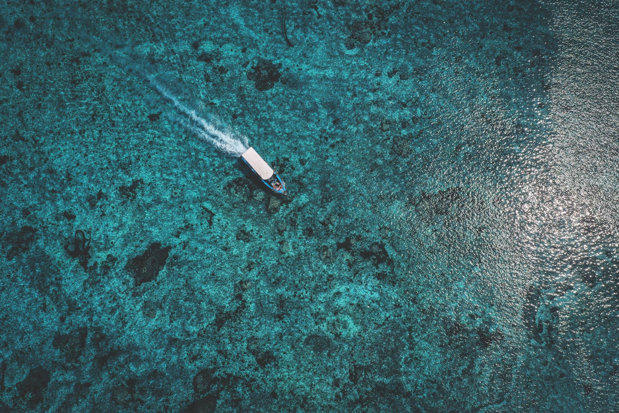 Lembongan transport boat driving over crystal clear ocean water