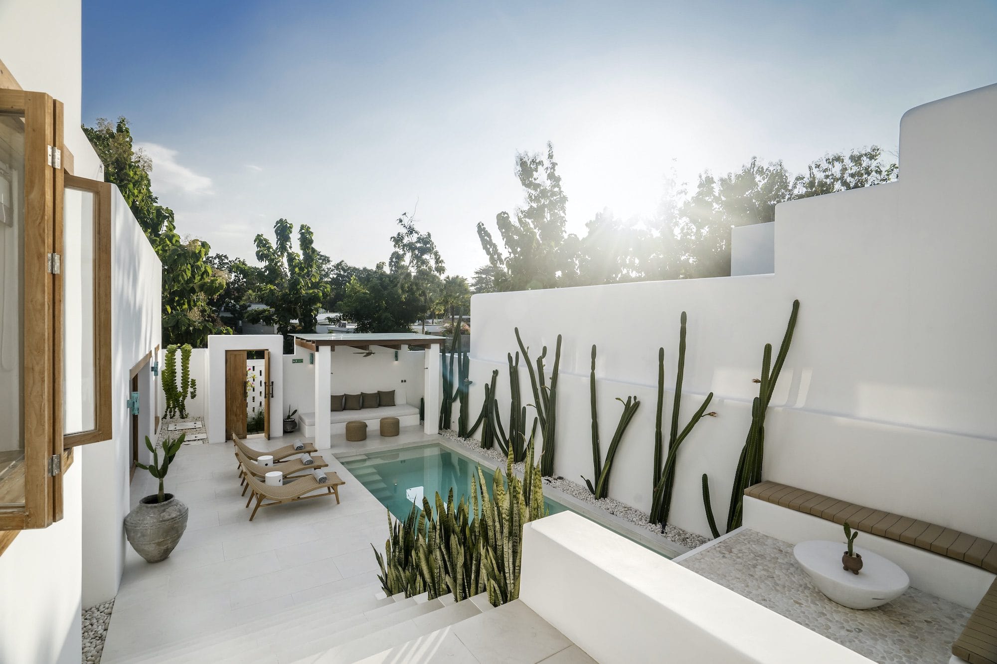 Pool and outside area of a private villa in Bingin seen while the sun is about to go down