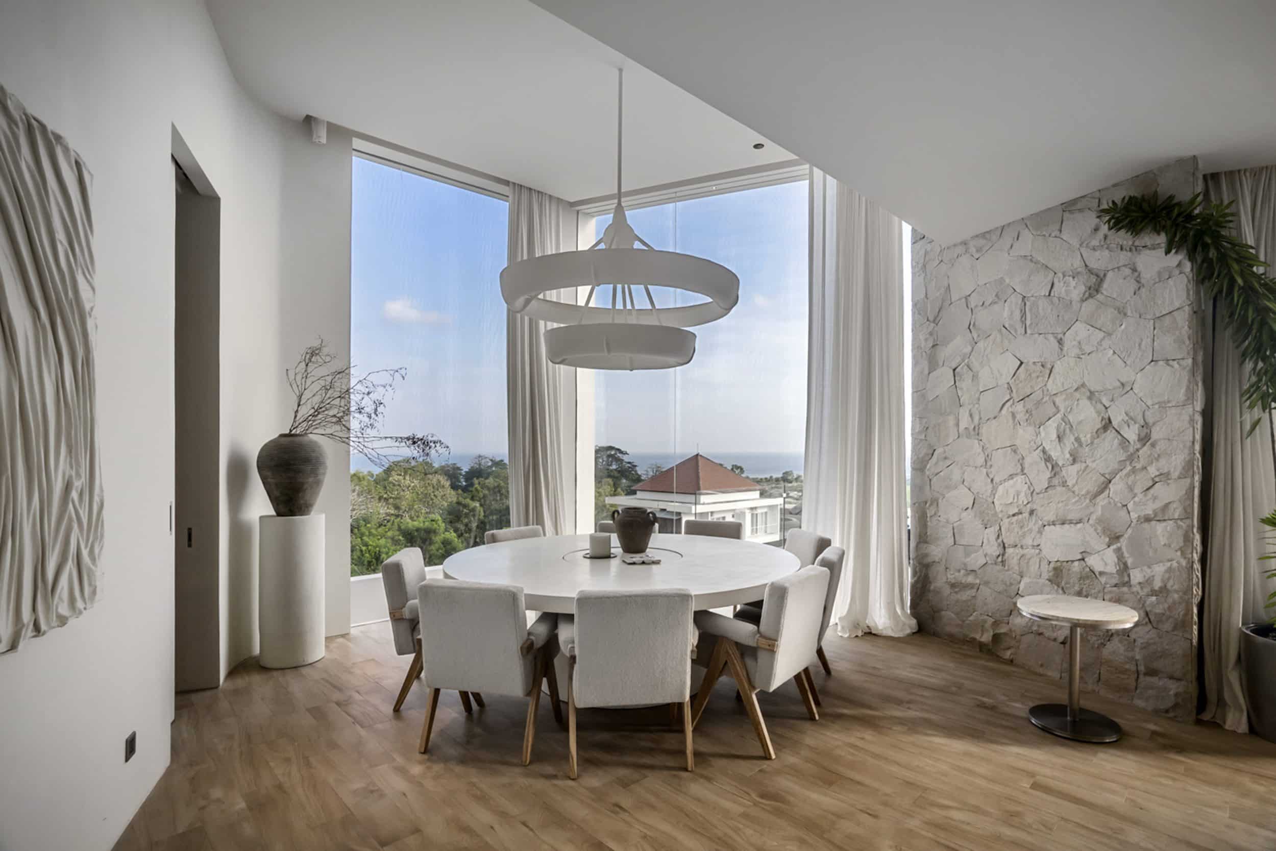 Dining table in the corner of a private villa in Bingin with ocean view in the distance