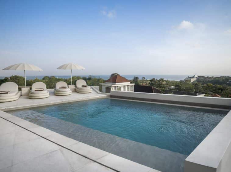 View from the pool of this private villa in Bingin with four sun loungers and ocean views