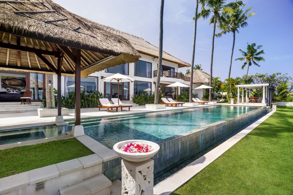 Expansive pool at Villa Blanca with sun loungers 