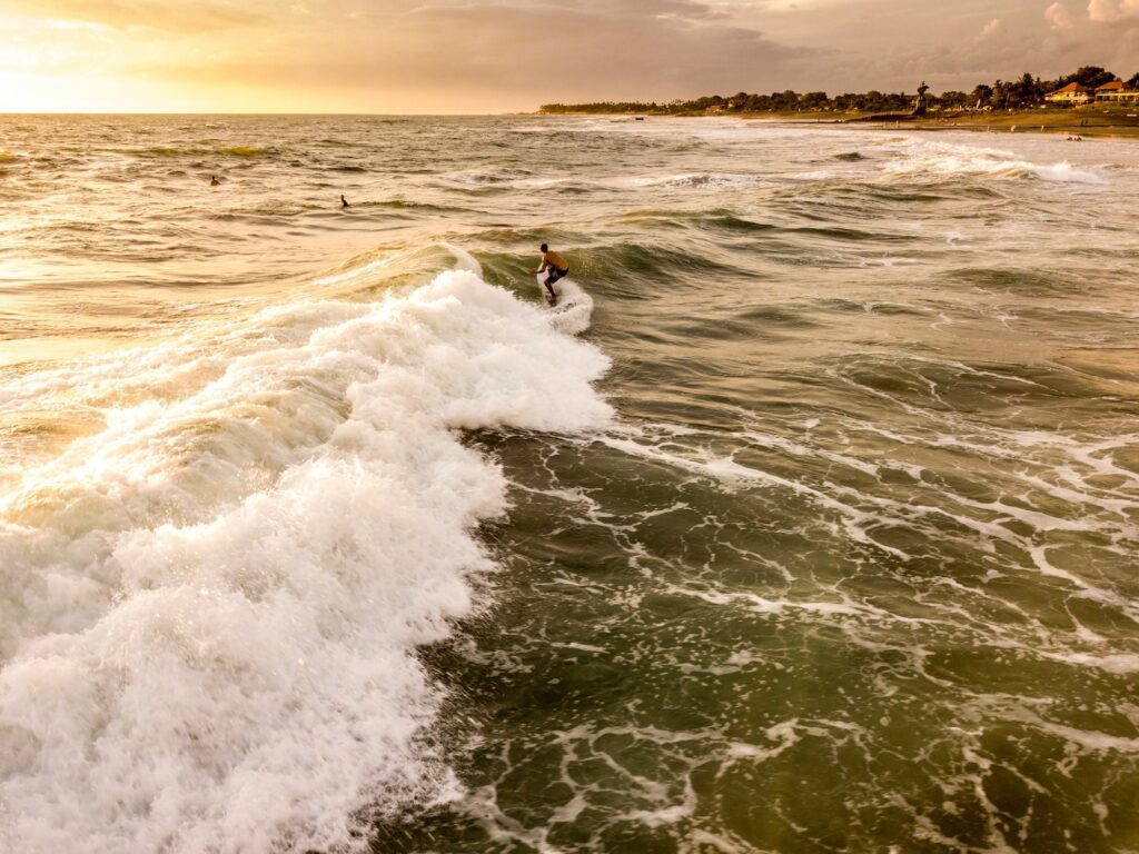 A surfer surfing at one of Bali beaches