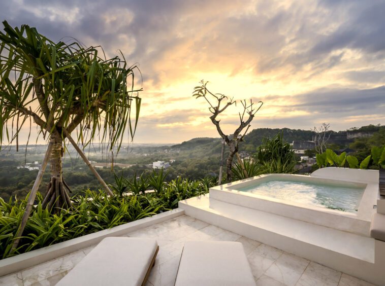 Pool with jet streams surrounded by panoramic views from the top of Uluwatu villa Kalani