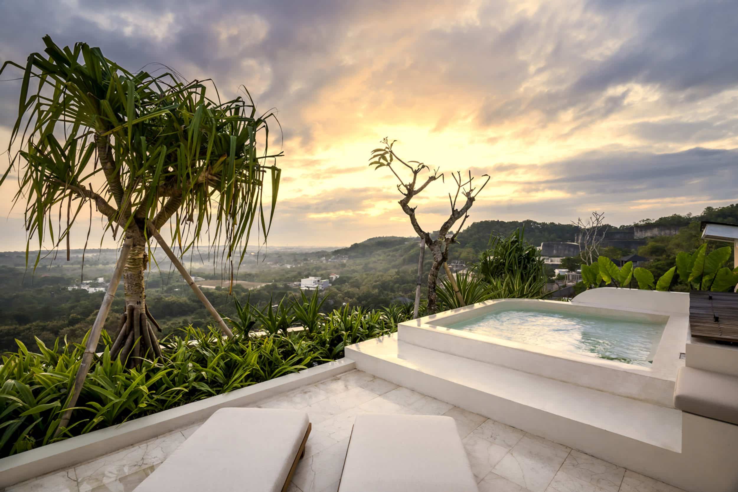 Pool with jet streams surrounded by panoramic views from the top of Uluwatu villa Kalani