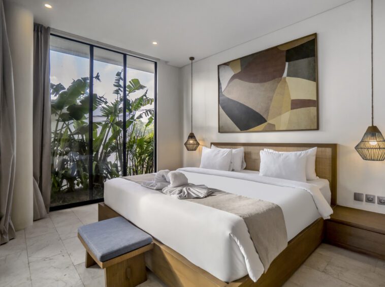 Bedroom in a Uluwatu villa with greenery outside the window