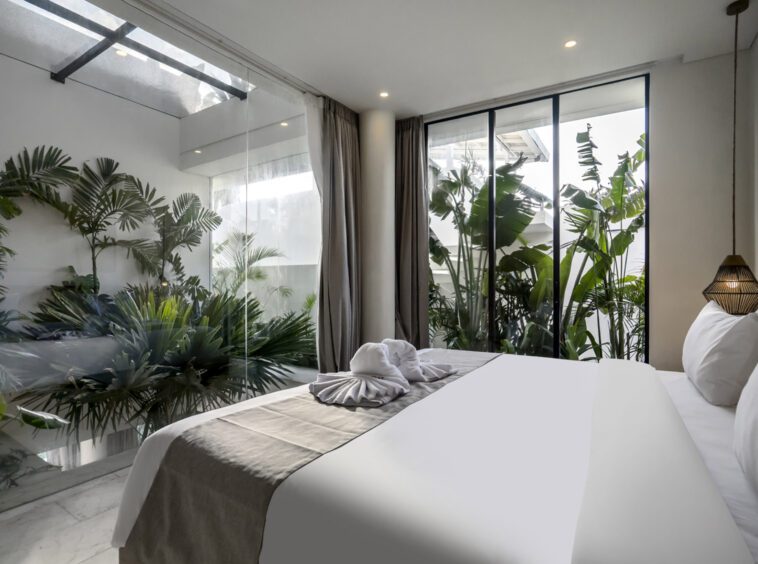 Bedroom at Uluwatu villa Kalani surrounded by lush greenery