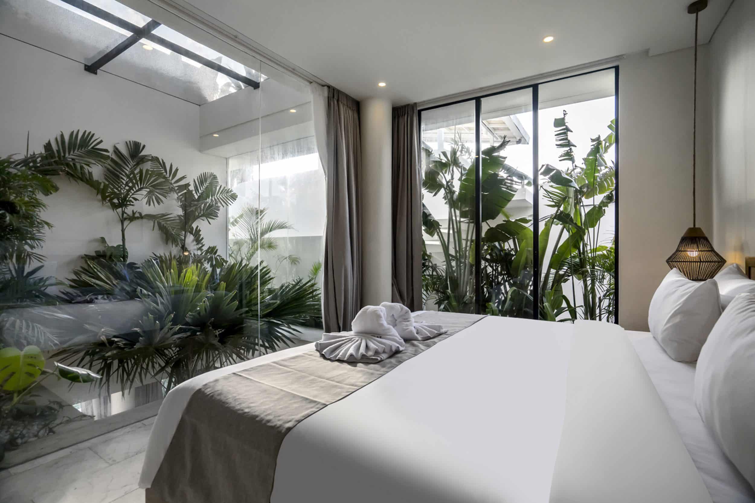 Bedroom at Uluwatu villa Kalani surrounded by lush greenery