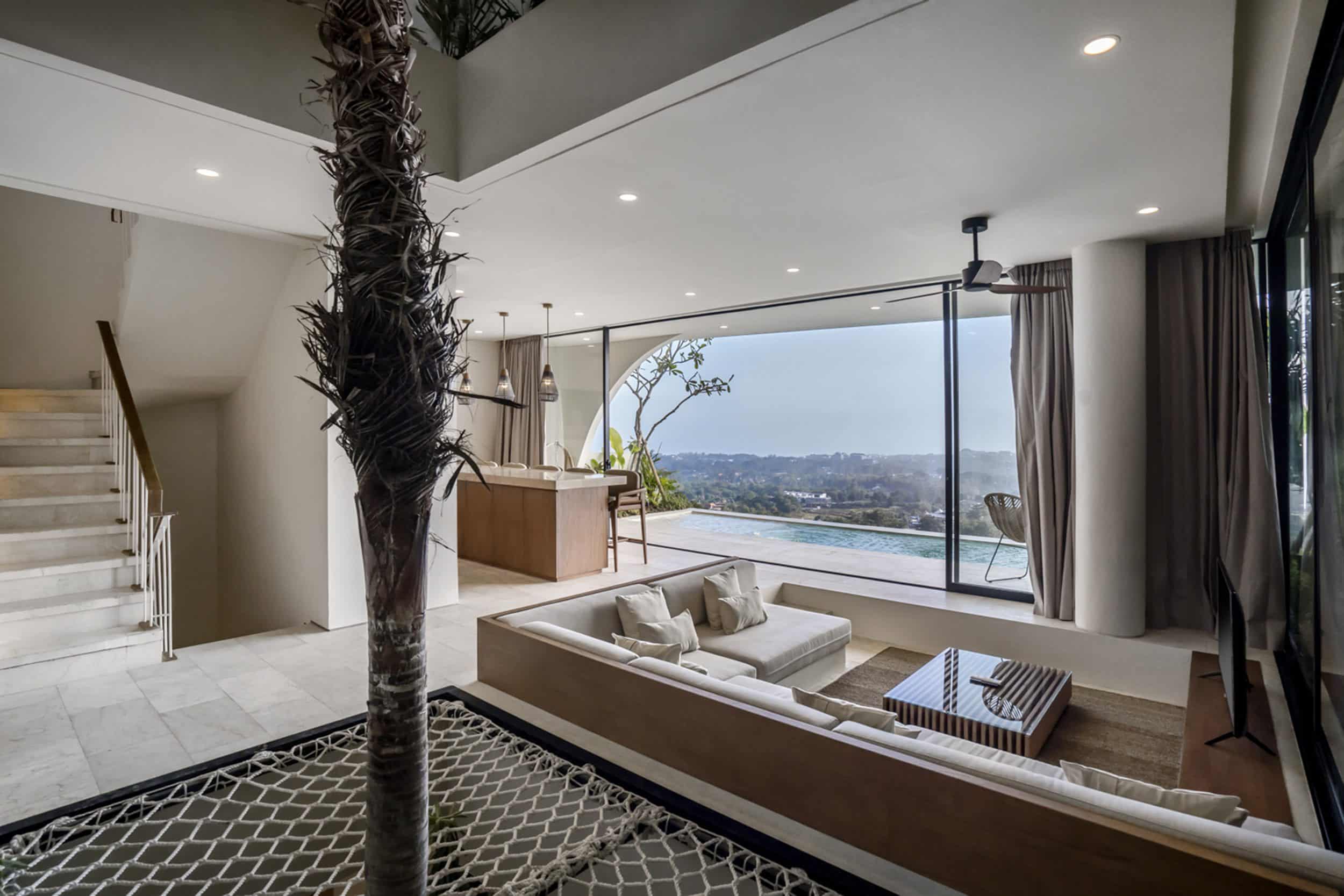 Living room of Uluwatu villa with palm tree in the centre